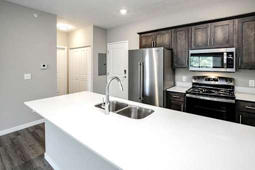 Modern kitchen with stainless steel appliances at Logan Creek Apartments in Wakefield, NE