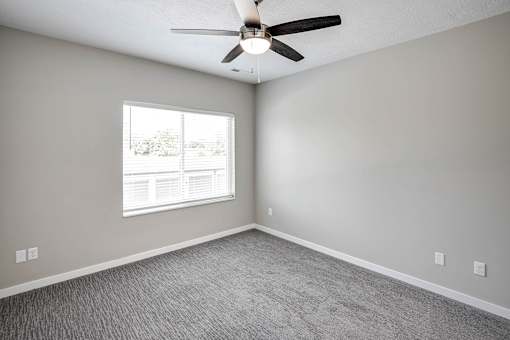 Bedroom with plush carpet at Logan Creek Apartments in Wakefield, NE
