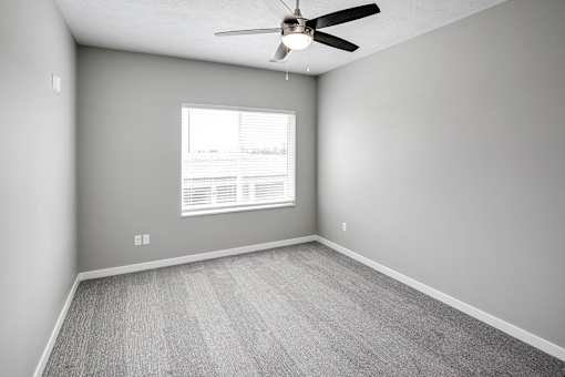 Bedroom with plush carpet at Logan Creek Apartments in Wakefield, NE