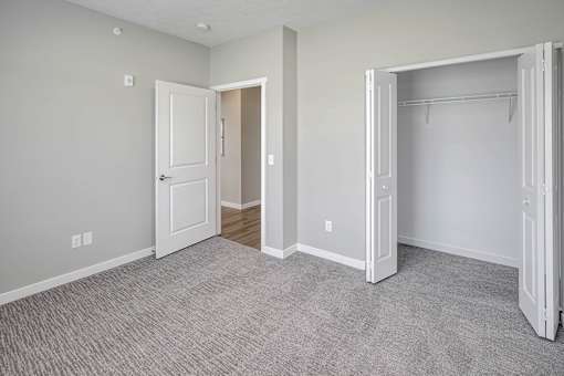 Bedroom with plush carpet at Logan Creek Apartments in Wakefield, NE