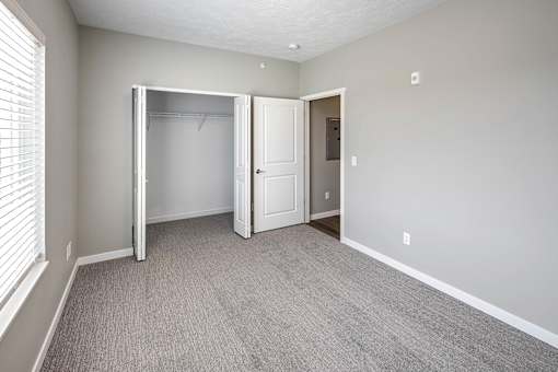 Bedroom with plush carpet at Logan Creek Apartments in Wakefield, NE