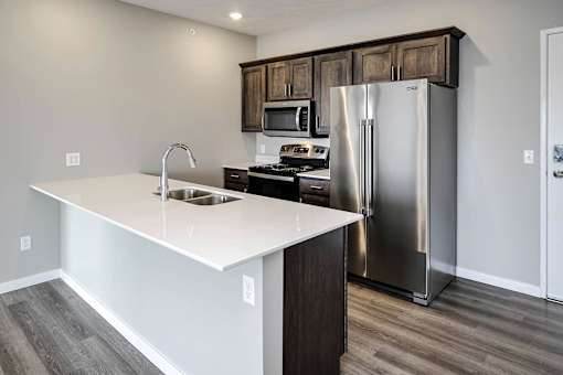 Modern kitchen with stainless steel appliances at Logan Creek Apartments in Wakefield, NE