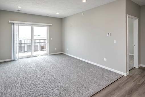 Living room with plush carpet at Logan Creek Apartments in Wakefield, NE