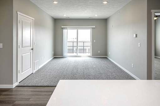 Living room with plush carpet at Logan Creek Apartments in Wakefield, NE