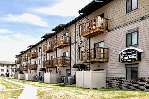 Apartment complex with balconies and a sign that reads "1021 Starwood at Oak Pointe".