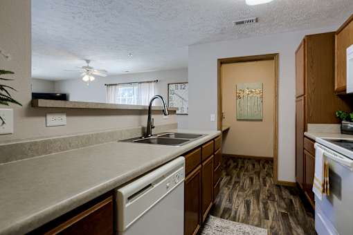 A kitchen with a sink, stove, and oven.