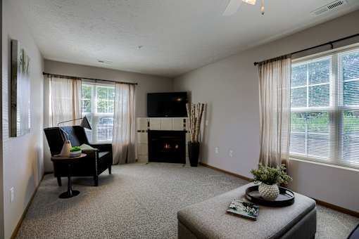 A living room with a fireplace and a chair.