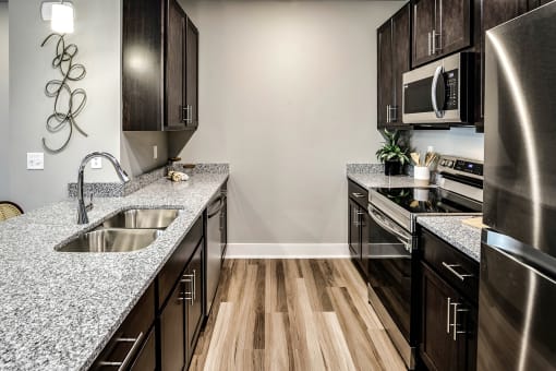 Kitchen with stainless steel appliances at Sterling Prairie Trail North in Ankeny, IA