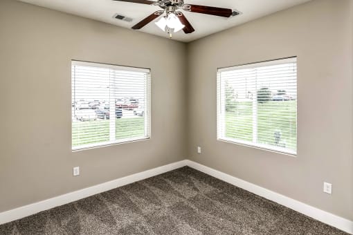 Bedroom with two windows at Tamarin Ridge in Lincoln, NE