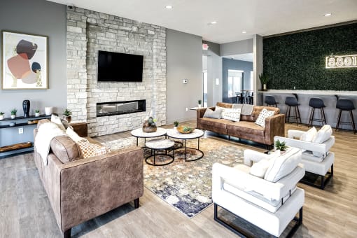 a living room with couches and chairs and a fireplace