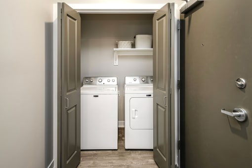 a laundry room with two white machines in it