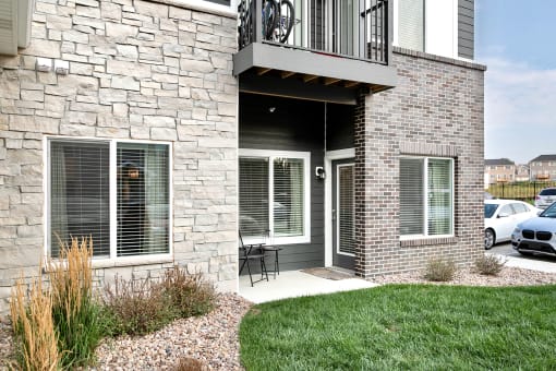 a patio with a table and chairs outside of a house