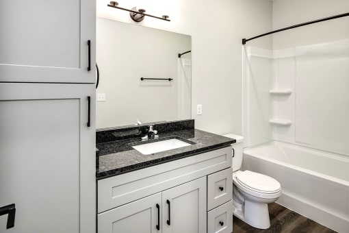 Spacious one and two-bedroom apartments featuring three interior schemes, granite countertops, stainless steel appliances, large kitchens, high-end lighting, vinyl plank flooring and much more at The Brink at Ridgeview in Plattsmouth, NE