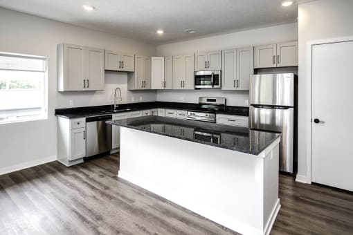 Spacious one and two-bedroom apartments featuring three interior schemes, granite countertops, stainless steel appliances, large kitchens, high-end lighting, vinyl plank flooring and much more at The Brink at Ridgeview in Plattsmouth, NE