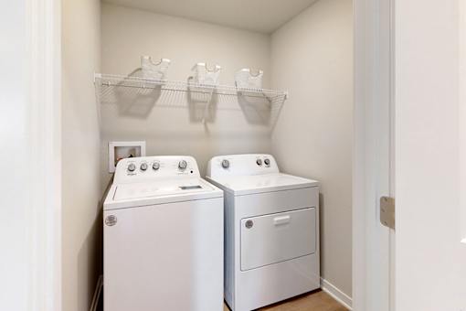 A small laundry room with a washer and dryer.