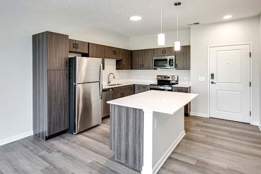 Studio, one two and three bedroom apartments and townhomes featuring open concept floor plans, dens, large windows, stainless steel appliances, quartz countertops, eat-in kitchens, pantries, LVT flooring and much more at The Trails at North Streams in Omaha, NE