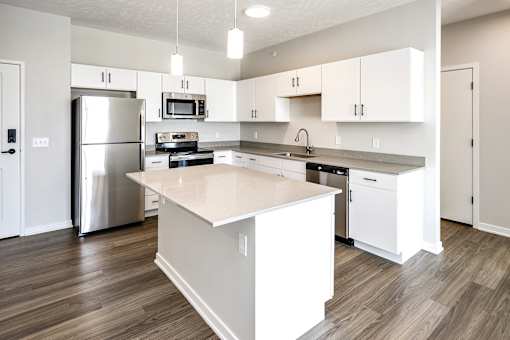 Studio, one two and three bedroom apartments and townhomes featuring open concept floor plans, dens, large windows, stainless steel appliances, quartz countertops, eat-in kitchens, pantries, LVT flooring and much more at The Trails at North Streams in Omaha, NE