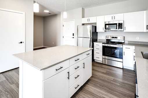 Studio, one two and three bedroom apartments and townhomes featuring open concept floor plans, dens, large windows, stainless steel appliances, quartz countertops, eat-in kitchens, pantries, LVT flooring and much more at The Trails at North Streams in Omaha, NE