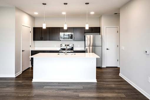 Studio, one two and three bedroom apartments and townhomes featuring open concept floor plans, dens, large windows, stainless steel appliances, quartz countertops, eat-in kitchens, pantries, LVT flooring and much more at The Trails at North Streams in Omaha, NE