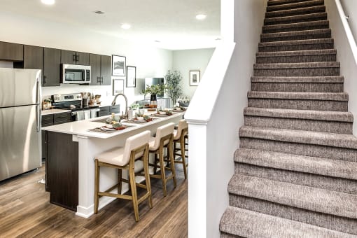 Studio, one two and three bedroom apartments and townhomes featuring open concept floor plans, dens, large windows, stainless steel appliances, quartz countertops, eat-in kitchens, pantries, LVT flooring and much more at The Trails at North Streams in Omaha, NE