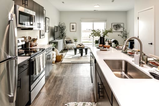 Studio, one two and three bedroom apartments and townhomes featuring open concept floor plans, dens, large windows, stainless steel appliances, quartz countertops, eat-in kitchens, pantries, LVT flooring and much more at The Trails at North Streams in Omaha, NE