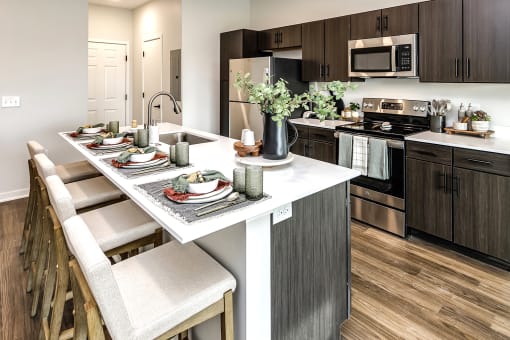 Studio, one two and three bedroom apartments and townhomes featuring open concept floor plans, dens, large windows, stainless steel appliances, quartz countertops, eat-in kitchens, pantries, LVT flooring and much more at The Trails at North Streams in Omaha, NE