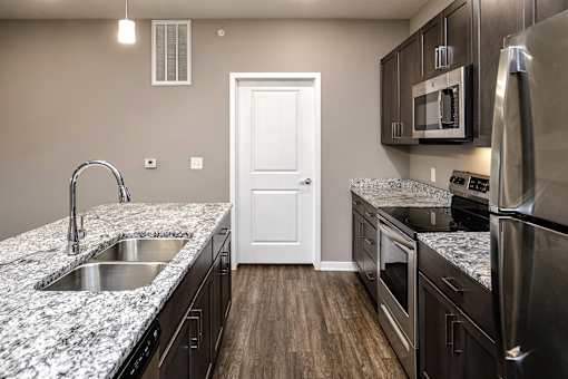 Studio, one two and three bedroom apartment homes featuring stainless steel appliances, luxury wood-style plank flooring, and in-unit washer and dryer in VUE 156 in Omaha, NE