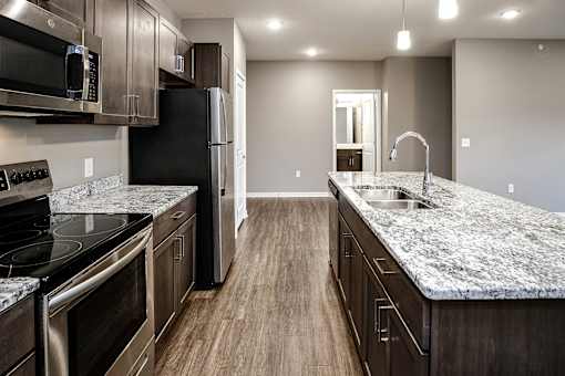 Studio, one two and three bedroom apartment homes featuring stainless steel appliances, luxury wood-style plank flooring, and in-unit washer and dryer in VUE 156 in Omaha, NE