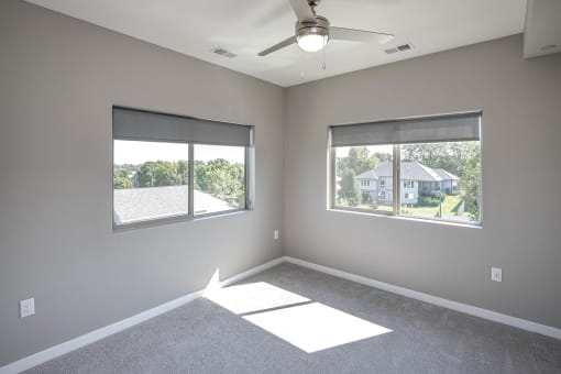 Bedroom with two windows at Vue 156 in Omaha, NE