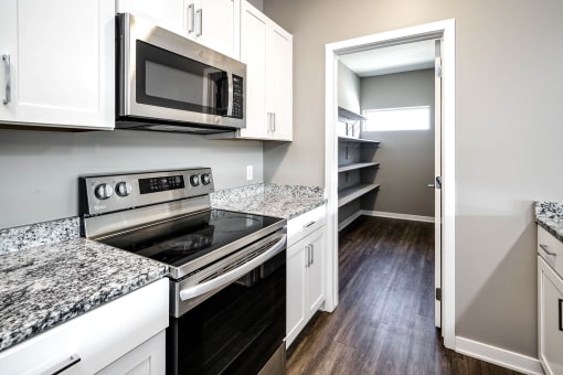 Studio, one two and three bedroom apartment homes featuring stainless steel appliances, luxury wood-style plank flooring, and in-unit washer and dryer in VUE 156 in Omaha, NE