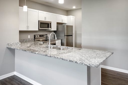 Studio, one two and three bedroom apartment homes featuring stainless steel appliances, luxury wood-style plank flooring, and in-unit washer and dryer in VUE 156 in Omaha, NE