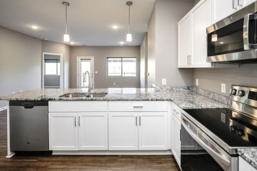 Studio, one two and three bedroom apartment homes featuring stainless steel appliances, luxury wood-style plank flooring, and in-unit washer and dryer in VUE 156 in Omaha, NE