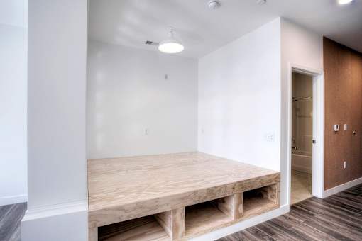 A room with a bed and a door.