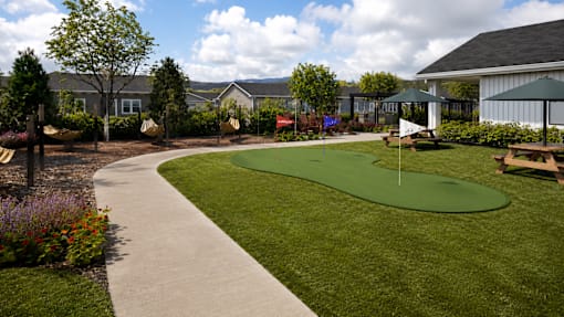 A green putting green in a backyard.