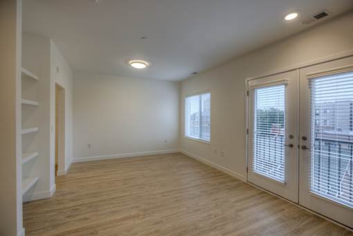 A room with wooden floors and white walls.