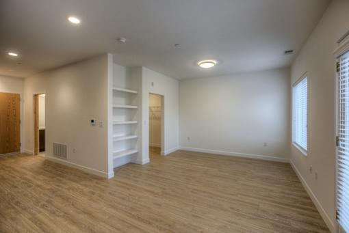 A room with wooden floors and white walls.