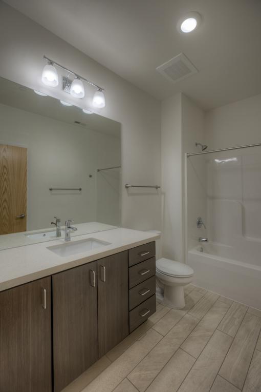 A bathroom with a sink, toilet, and bathtub.