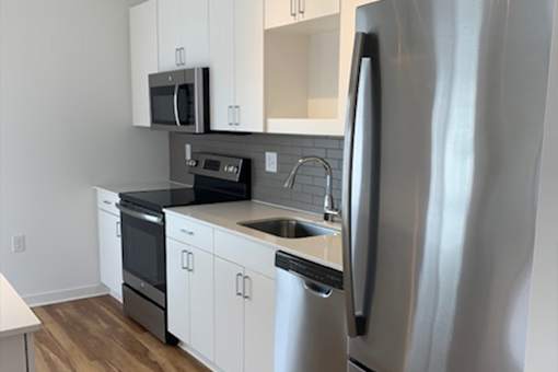 A modern kitchen with a stainless steel refrigerator.
