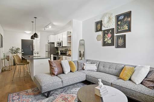 A grey couch with pillows sits in a living room.