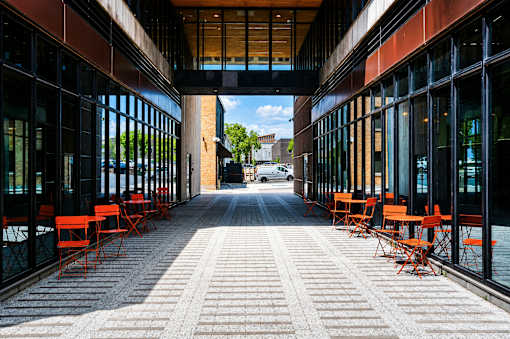 A long covered walkway with tables on either side.
