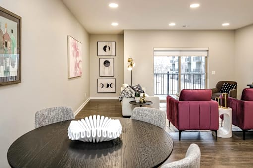 A modern dining room with a round table and chairs.