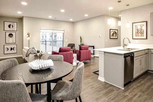 A modern kitchen with a dining table and chairs.
