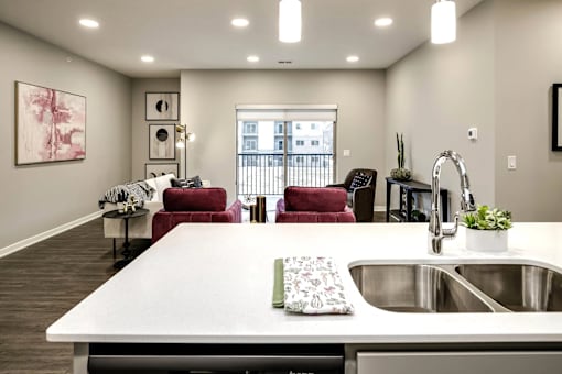 A modern kitchen with a large island and a view of the city.