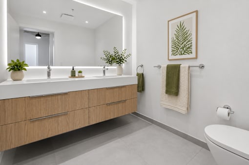 A bathroom with a white tub, sink, and a mirror.