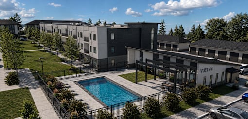 A large building with a pool in front of it.