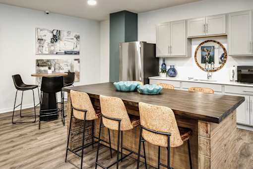 VUE 19 (Clubhouse) -Kitchen with a bar area and chairs.