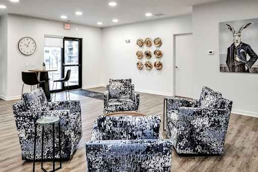 VUE 19 (Clubhouse) - Black and white patterned couch, two chairs, and a table.