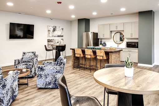 VUE 19 (Clubhouse) - Modern kitchen and dining area with a wooden table and chairs.