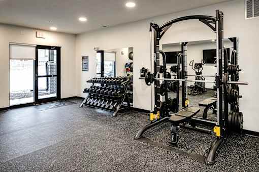 VUE 19 (Fitness Center) -gym with a squat rack, bench, and weights.