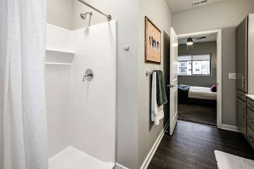 VUE 19 (Model 2Bd) - Bathroom with a white shower curtain and a white shower head.
